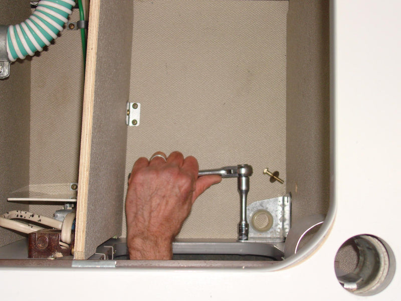 Unbolt and remove the existing bracket from inside the rear cabinet.