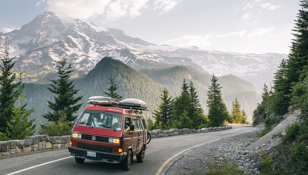 Van driving on coastline road with the ocean in the background