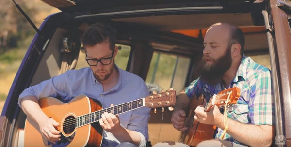 Pictured: Bart Budwig and another man performing with guitars in the back of a camper van