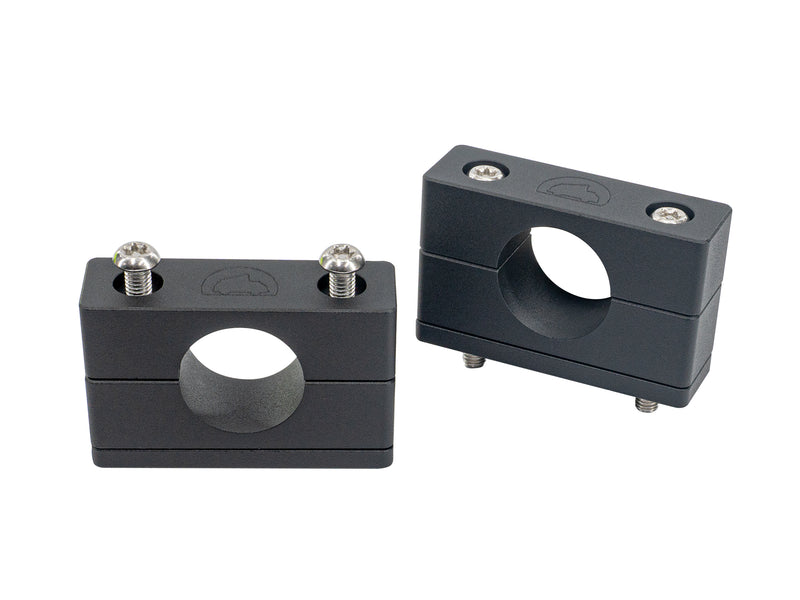Two black metal blocks with circular holes and screws on a white background