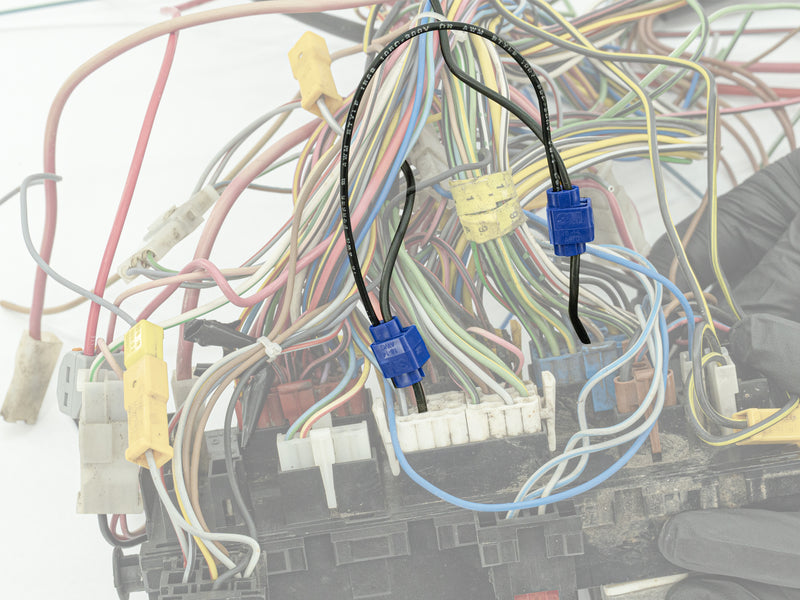 Close-up of automotive wiring harness with connectors.